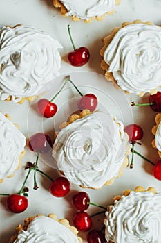 Beautiful chocolate cupcakes with white protein cream and cherry