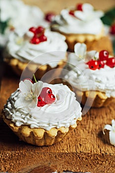 Beautiful chocolate cupcakes with white protein cream and cherry