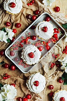 Beautiful chocolate cupcakes with white protein cream and cherry