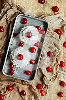 Beautiful chocolate cupcakes with white protein cream and cherry