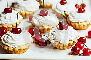 Beautiful chocolate cupcakes with white protein cream and cherry