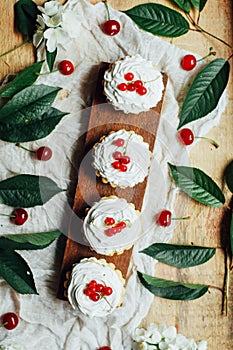 Beautiful chocolate cupcakes with white protein cream and cherry