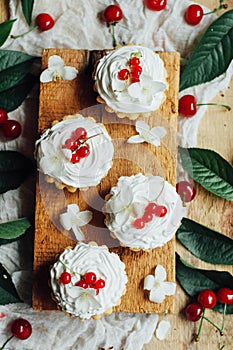 Beautiful chocolate cupcakes with white protein cream and cherry