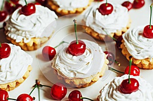 Beautiful chocolate cupcakes with white protein cream and cherry