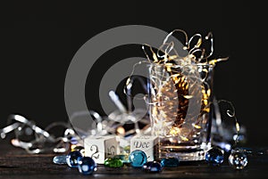 Beautiful Christmas background with  block calendar and glowing Christmas lights in a glass jar