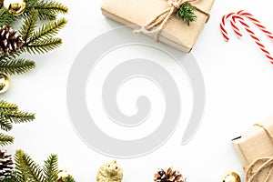 Beautiful Christmas background with gift box, decorate with pine branch and pine cone over white background. Top view with copy sp