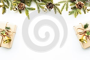 Beautiful Christmas background with gift box, decorate with pine branch and pine cone over white background. Top view with copy sp