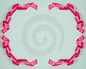 Beautiful Christmas Background with Shiny Pink Ribbon in Bright Color. Top view with Copy Space. Round Red Ornament