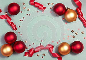 Beautiful Christmas Background with Shiny Red Balls, Glitter Stars and Ribbon in Bright Color. Top view with Copy Space