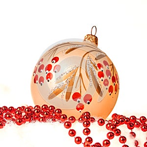Beautiful Christmas ball with red beads isolated on white background