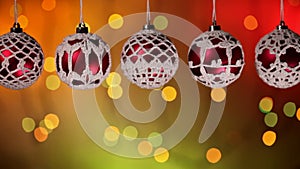 Beautiful christmas baubles hanging against blinking xmas lights background