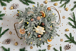 Beautiful Christmas bouquet. Christmas composition with fir branches, cones and festive decor on a gray background. New Year