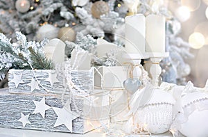 Beautiful Christmas card. Christmas background 2021. White Christmas balls, box with gifts, candle on the background of the