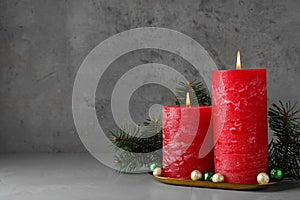 Beautiful Christmas composition with burning red candles on background. Space for text