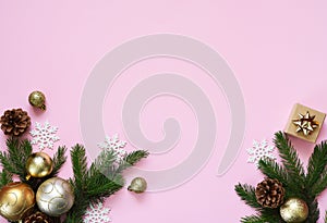 Beautiful Christmas composition on a red background with fir. Pink background with fir, christmas balls and decor. Top view with