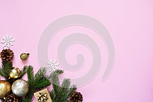 Beautiful Christmas composition on a red background with fir. Pink background with fir, christmas balls and decor. Top view with