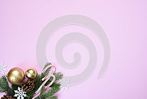 Beautiful Christmas composition on a red background with fir. Pink background with fir, christmas balls and decor. Top view with