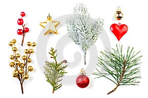 Beautiful Christmas composition. Red holly berries, golden star, glass baubles and green fir branch isolated on white background