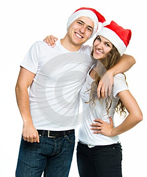 Beautiful Christmas couple in Santa hats