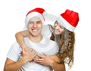 Beautiful Christmas couple in Santa hats