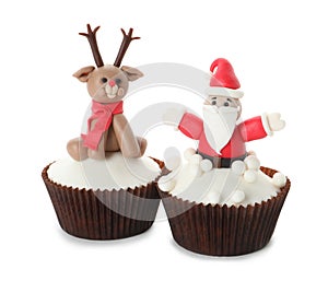 Beautiful Christmas cupcakes with Santa Claus and reindeer on white background