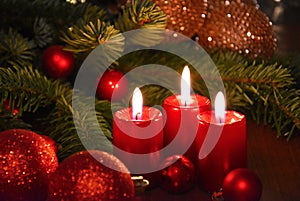 Beautiful christmas decoration with burning red candles and fir tree branch stock images