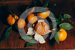 Beautiful Christmas decoration with tangerines in the night light garlands. Citrus still life. The symbol of the new year