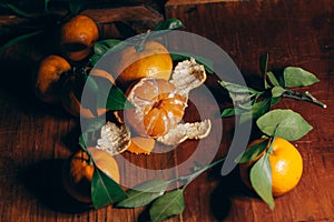 Beautiful Christmas decoration with tangerines in the night light garlands. Citrus still life. The symbol of the new year