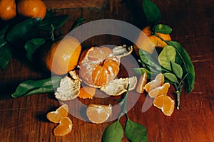 Beautiful Christmas decoration with tangerines in the night light garlands. Citrus still life. The symbol of the new year