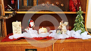 Beautiful Christmas decorations and candles on brown shelf