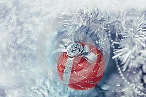 Beautiful Christmas decorations in the shape of a red ball hanging on the Christmas tree. Home decoration for Christmas