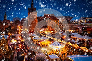 Beautiful Christmas fair in the old town of Gdansk at snowy night, Poland photo