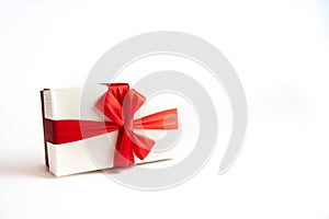 Beautiful Christmas gift box with red ribbon on isolated background. Happy New Year and merry christmas