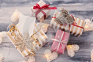 Beautiful Christmas gift boxes with decorations on wooden table