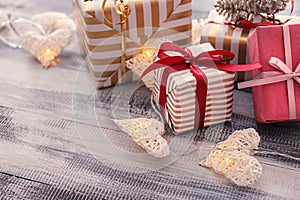 Beautiful Christmas gift boxes with decorations on wooden table