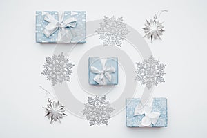 Beautiful christmas gifts and silver snowflakes isolated on white background. Christmas composition.