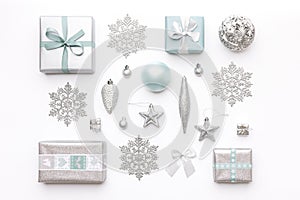 Beautiful christmas gifts and silver snowflakes and ornaments isolated on white background. Christmas composition.