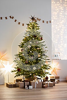 Beautiful christmas interior with christmas tree, stars, gifts and decoration. Winter holiday home decor template