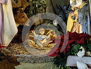 Beautiful Christmas nativity scene with holy family in a handmade wooden old stable, Italian traditional Presepio or Presepe