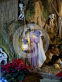 Beautiful Christmas nativity scene with holy family in a handmade wooden old stable, Italian traditional Presepio or Presepe