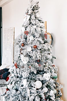 Beautiful Christmas tree in bright white living room