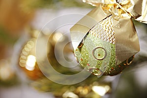 Beautiful Christmas tree decoration bright shiny golden ball close-up.