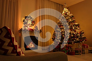 Beautiful Christmas tree and gifts near fireplace in festively decorated living room