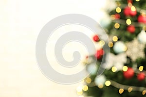 Beautiful Christmas tree with lights against background, blurred view. Space for text