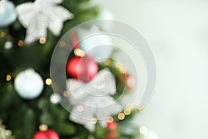 Beautiful Christmas tree with lights against background, blurred view. Space for text