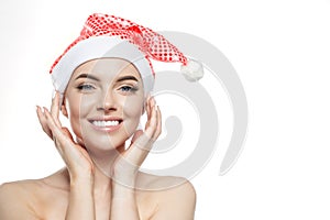 Beautiful Christmas Woman. Beauty Girl in the New Year. Model in a Santa hat