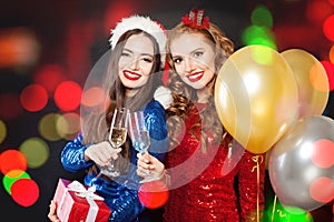 Beautiful Christmas women smiling. Winter fashion girls on abstract bokeh glitter sparkle party background