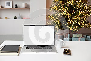 Beautiful Christmas workplace, laptop computer with blank white mockup screen. Online shopping during winter holiday concept.