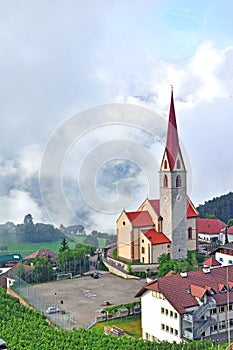 Beautiful church in mountains with clouds on background