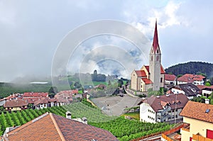 Beautiful church in mountains with clouds on background